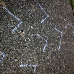 Chalk arrow trail on sidewalk